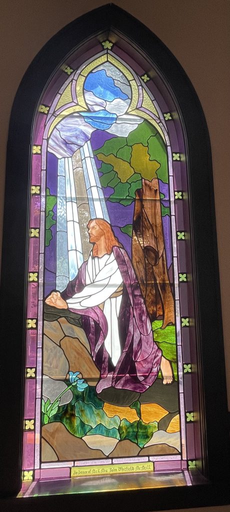 Stained glass window depicting Jesus praying