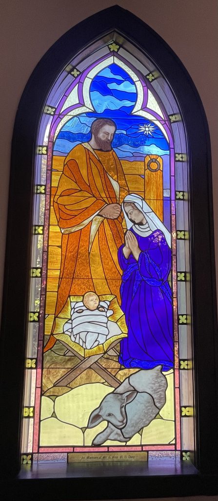 Stained glass window depicting Mary, Joseph and the baby Jesus