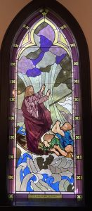 Stained glass art depicting Jesus crossing the Red Sea